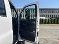 A 2005 GMC C7500 Topkick with the driver's door open showcasing the interior features and dashboard