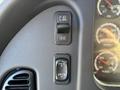 Close-up of the dashboard controls in a 2006 Freightliner M2 106 featuring a light switch and adjustment buttons for vehicle settings