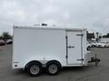 A 2016 Continental cargo trailer in white with a rounded top two axles and a side door