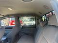 Interior view of a 2010 Toyota Tacoma showing the rear seating area with gray upholstery and ample space