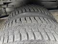 Close-up view of two worn tires from a 2012 Ford E-450 Super Duty showcasing tread patterns and rubber texture