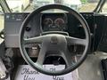 The image shows the driver's view of a 2020 Freightliner MT45 with a circular steering wheel dashboard gauges and a key in the ignition