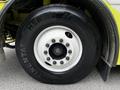 Close-up of a white wheel with a five-bolt pattern and a large black tire labeled HSR mounted on a 1995 Freightliner FL086