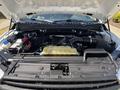 The image shows the open hood of a 2019 Ford F-150 revealing the engine compartment with various components including the engine air intake and battery