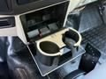 A 2009 Ford F-550's dashboard showing an open cup holder with a compartment above it for storage