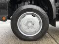 Close-up of a silver wheel rim on a 2015 Hino 195 truck with a black tire mounted on it