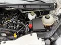 Engine compartment of a 2017 Ford Transit showing various components including the battery reservoir hoses and electrical connections