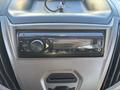 A Clarion car stereo system with buttons and a display located in the dashboard of a vehicle