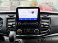 Dashboard of a 2020 Ford Transit showing a digital display with radio information climate controls and USB ports