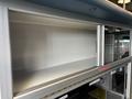 A 2020 Mercedes-Benz Sprinter 2500 interior cabinet with a silver frame and a spacious empty compartment for storage