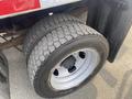 A close-up of a large tire mounted on a 2016 RAM 5500 with deep treads and a steel rim