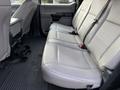 Interior of a 2020 Ford F-550 showing the back bench seat with gray upholstery and seat belts