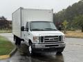 A 2022 Ford Econoline truck in white with a large box cargo area and front grille featuring the Ford logo