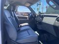 Interior view of a 2015 Ford F-450 SD featuring leather seats and a dashboard with a touchscreen display and control panel