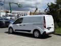 A white 2021 Ford Transit Connect van with a sliding side door and black trim parked on a concrete surface