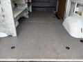 Interior view of a 2017 Mercedes-Benz Sprinter van showing an empty cargo space with a flat gray floor and metal shelving along one side