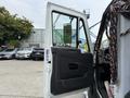 A 2012 International TerraStar truck with the driver's side door open showcasing the interior door panel and seat