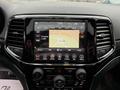 Interior display of a 2019 Jeep Grand Cherokee showing navigation map radio and climate controls