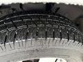 Close-up view of a wet tire from a 2020 Chevrolet Express showcasing detailed tread pattern and water droplets on the surface