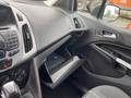 Interior view of a 2017 Ford Transit Connect showcasing the dashboard with controls radio and glove compartment