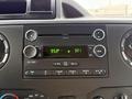 A car stereo display showing the radio frequency 95.3 FM and the time 3:21 with various control buttons beneath