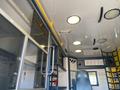 Interior view of a 2011 Chevrolet Express van featuring seating areas overhead compartments and lighting fixtures