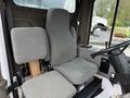 Interior of a 2012 Global M4 truck showing two gray fabric seats and a steering wheel with controls