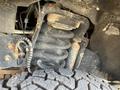 Close-up of a rusty suspension spring and components of a 2017 Ford F-250 SD truck including a tire showing tread pattern
