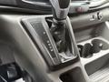 The gear shifter of a 2020 Ford Transit featuring a leather boot with indicators for park reverse neutral and drive