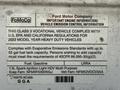 A Ford E-450 vehicle information label detailing compliance with EPA standards and specifications for fuel type and emission controls.