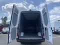 A 2024 Mercedes-Benz Sprinter van with its rear doors open revealing a spacious cargo area