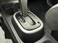 Close-up of the gear shift console in a 2012 Nissan Versa showing the gear selector with positions for park reverse neutral and drive