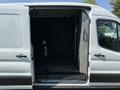 A 2022 Ford Transit van with an open side door revealing an empty cargo area