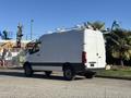 A 2024 Mercedes-Benz Sprinter 2500 van parked with a white exterior and roof-mounted equipment visible on top