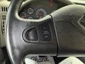 Close-up of the steering wheel of a 2016 International 7400 featuring control buttons for cruise and throttle settings