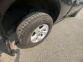 A close-up of a tire on a 2015 RAM 1500 showing detailed tread and shiny alloy rim
