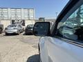 A 2017 Chevrolet Colorado parked with a side view mirror visible in the foreground