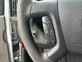 Close-up of the steering wheel of a 2018 Chevrolet Express featuring cruise control buttons for resume, set, and other functions