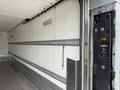 Interior view of a 2019 Ford F-750 showing the rear loading area with metal strips and a lift gate control panel