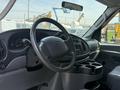 Interior view of a 2008 Ford Econoline showing the dashboard steering wheel and center console with cup holders