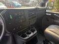 Interior view of a 2021 Chevrolet Express showing the dashboard controls and center console with cup holders