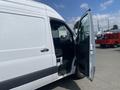 A 2025 Mercedes-Benz Sprinter van with an open side door showcasing the interior seating and dashboard