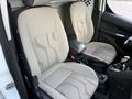 Interior view of a 2017 Ford Transit Connect showing two light gray front seats with patterned fabric and a console in between them