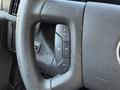 Close-up of the steering wheel of a 2020 Chevrolet Express with buttons for cruise control settings and a textured grip