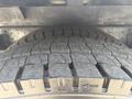 Close-up of a tire on a 2012 Hino 338 showing detailed tread patterns and grooves designed for traction
