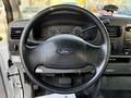 Steering wheel of a 2006 Ford F-550 with the Ford logo and dashboard instruments visible behind it