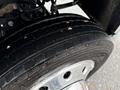 Close-up of a 2024 RAM 5500 tire showcasing the tread pattern and wheel rim with visible details of the tire's surface and rubber grooves