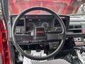 Interior view of a 2002 GMC C7500 with a bold steering wheel featuring a GMC logo dashboard displays gauges and controls in front of the driver seat