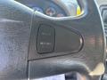 Close-up of the steering wheel of a 2013 International 7500 featuring cruise control buttons labeled Cruise and Resume/Accel