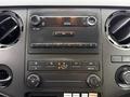 Dashboard controls of a 2016 Ford F-550 Super Duty featuring buttons for audio climate settings and a digital clock
